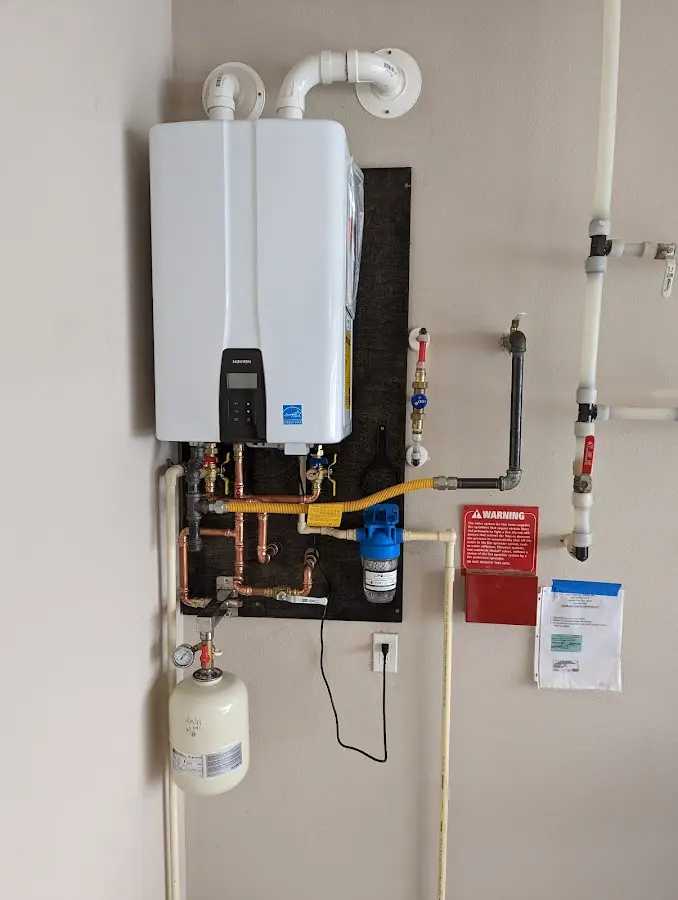 Professional plumber installing copper piping in a Kennebunkport home